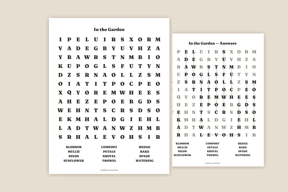 Two printed word search sheets lying on a warm paper-coloured surface — the front one headed In the Garden, twelve big letters to a row with its word list underneath, and the answer sheet behind it showing the found words in solid black with faint lines drawn through them.